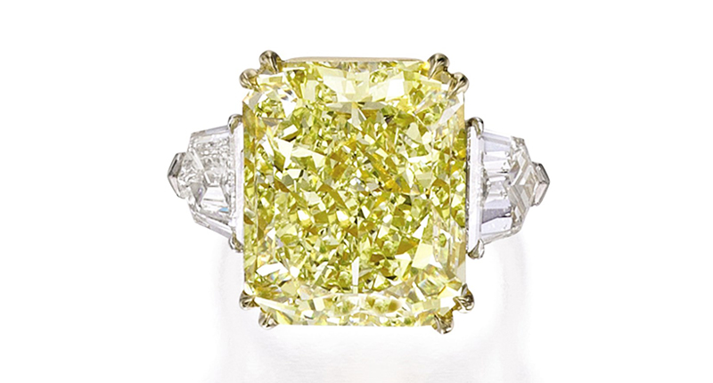 A platinum and 18-karat gold ring boasting a cut-cornered rectangular modified brilliant-cut fancy yellow 16.48-carat diamond and 1.50-carats of shield-cut diamond on the side sold for $225,000. A platinum and 18-karat gold ring boasting a cut-cornered rectangular modified brilliant-cut fancy yellow 16.48-carat diamond and 1.50-carats of shield-cut diamond on the side sold for $225,000.
