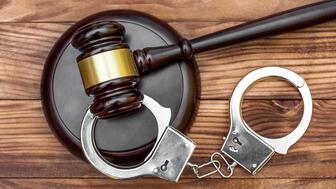 Stock image of a gavel and handcuffs