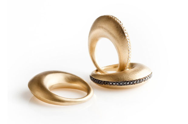 The 18-karat brushed yellow gold “Aya” rings are available in gold ($2,780) with a white diamond line ($5,350) or a black diamond line ($4,190). The rings are also available in 18-karat white gold. The 18-karat brushed yellow gold “Aya” rings are available in gold ($2,780) with a white diamond line ($5,350) or a black diamond line ($4,190). The rings are also available in 18-karat white gold.