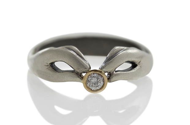 The “In Our Hands” ring by Luana Coonen features two realistic hands holding a 1940s transitional-cut round diamond set in 14-karat white and yellow gold ($1,190). <a href="http://www.luanacoonen.com/" target="_blank"><span style="color: rgb(255, 0, 0);">LuanaCoonen.com</span></a>