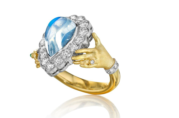 Anthony Lent’s “Pavé Hands” ring, in 18-karat yellow gold and platinum with moonstone, diamonds and one dainty emerald cabochon ($19,200) <a target="_blank" href="http://www.anthonylent.com/"><span style="color: #ff0000;"><br />
anthonylent.com</span></a>