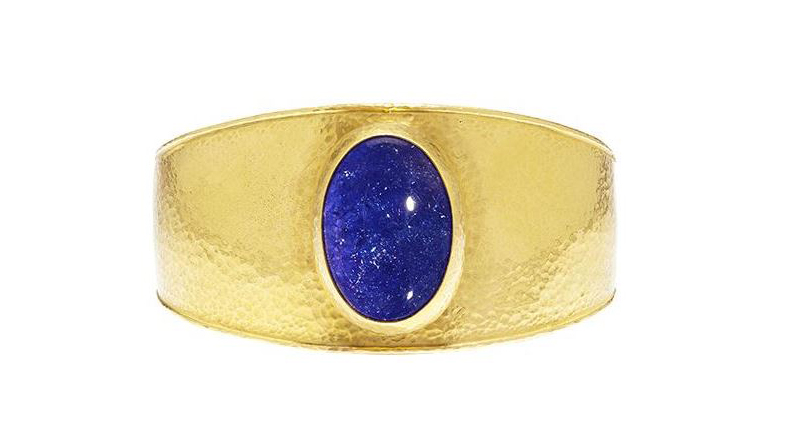 Gurhan’s one-of-a-kind Amulet Hue cuff in 22-karat gold featuring an oval cabochon tanzanite with a 24-karat gold bezel