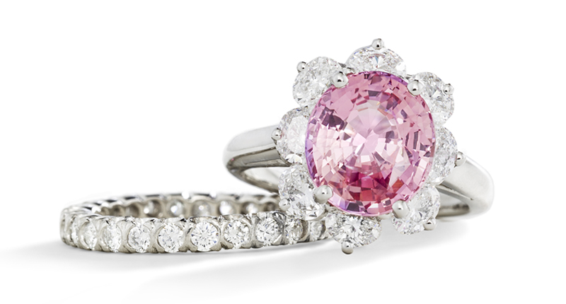 Oscar Heyman’s platinum ring with 5.01-carat no-heat padparadscha sapphire and eight oval diamonds totaling 1.34 carats, and a platinum eternity band with 28 round diamonds totaling 1.08 carats