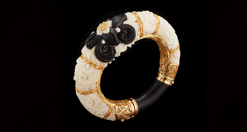 A cuff with carved tagua seed, black wood, a diamond and 22-karat gold