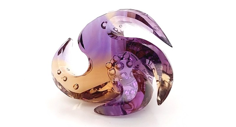 <strong>Innovative Faceting.</strong> Thomas Trozzo of Trozzo’s 70-carat freeform faceted and carved ametrine <strong>Innovative Faceting.</strong> Thomas Trozzo of Trozzo’s 70-carat freeform faceted and carved ametrine