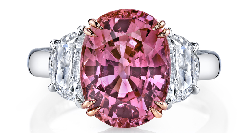 Omi Privé’s three-stone ring features a 7.18 carat oval padparadscha sapphire and 1.40 carts of half-moon white diamonds, set in platinum and 18-karat rose gold. 