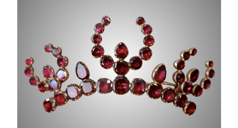 This Georgian high-karat gold and flat-cut garnet brooch is English circa 1800. From Elizabeth Rose Antiques, it was previously an aigrette, or hair piece. 