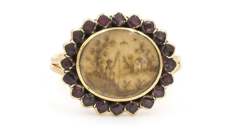 This sepia hairwork and garnet ring is another mourning piece, which Potts converted from a brooch. It depicts a scene of a man fishing to commemorate a death. “By using the person’s hair and grinding it up into a paste with water, this was painstakingly painted onto an ivory disc to depict their deceased loved one,” Potts said.