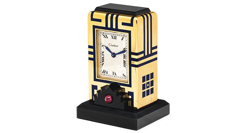 A circa 1928 Art Deco “Mignonette” Cartier clock featuring blued steel hands, onyx, blue enamel, cabochon rubies and gold (estimated to sell for between $16,000 and $21,000)