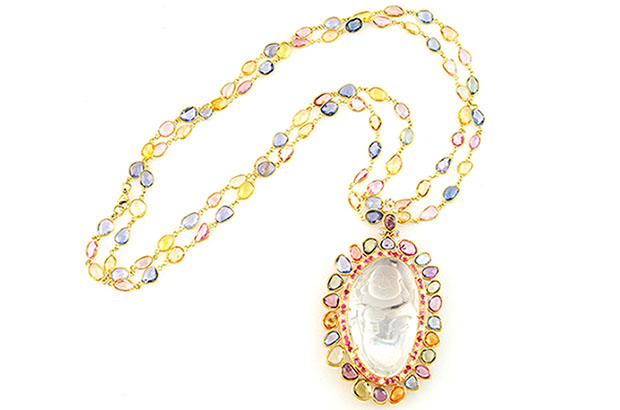 This crystal quartz “Happy Buddha” pendant features multi-colored sapphires and diamonds and is made in 18-karat gold ($25,000). This crystal quartz “Happy Buddha” pendant features multi-colored sapphires and diamonds and is made in 18-karat gold ($25,000).