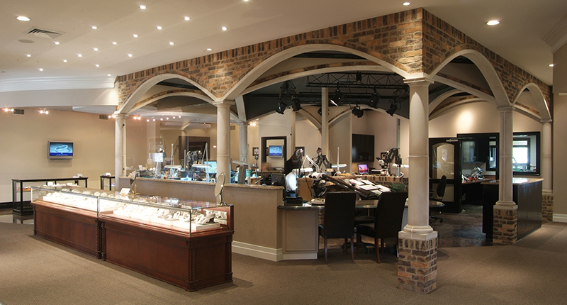 The setup of David Gardner’s Jewelers & Gemologists gives customers a peek into the design process, with the retailer’s bench jewelers seated in an open design studio located in the center of the store. The setup of David Gardner’s Jewelers & Gemologists gives customers a peek into the design process, with the retailer’s bench jewelers seated in an open design studio located in the center of the store.