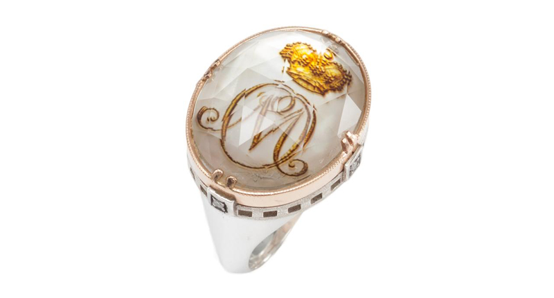 An oval monogram ring with a golden crown, “M” initial and four diamonds weighing 0.06 carats, made in 18-karat rose gold and sterling silver ($2,000) An oval monogram ring with a golden crown, “M” initial and four diamonds weighing 0.06 carats, made in 18-karat rose gold and sterling silver ($2,000)
