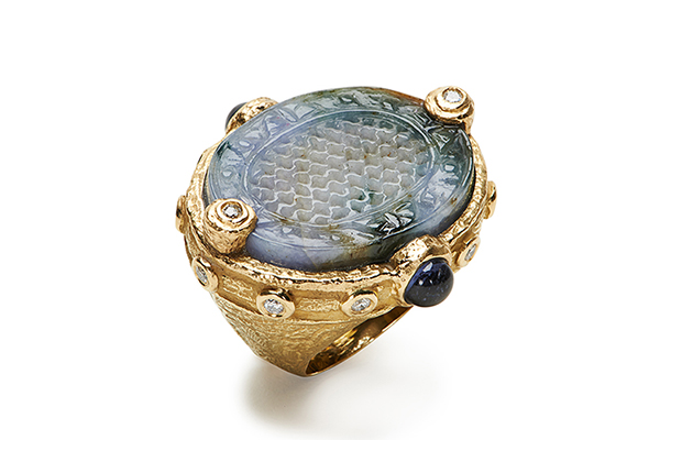 Briscoe’s one-of-a-kind, hand-carved blue Burmese jade ring set in 18-karat yellow gold with violet spinel cabochon and diamonds ($15,000) Briscoe’s one-of-a-kind, hand-carved blue Burmese jade ring set in 18-karat yellow gold with violet spinel cabochon and diamonds ($15,000)