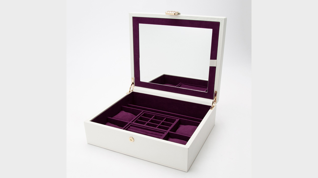 The interior of Vahan’s jewelry box has removable trays and a mirror that opens to reveal necklace storage. The interior of Vahan’s jewelry box has removable trays and a mirror that opens to reveal necklace storage.