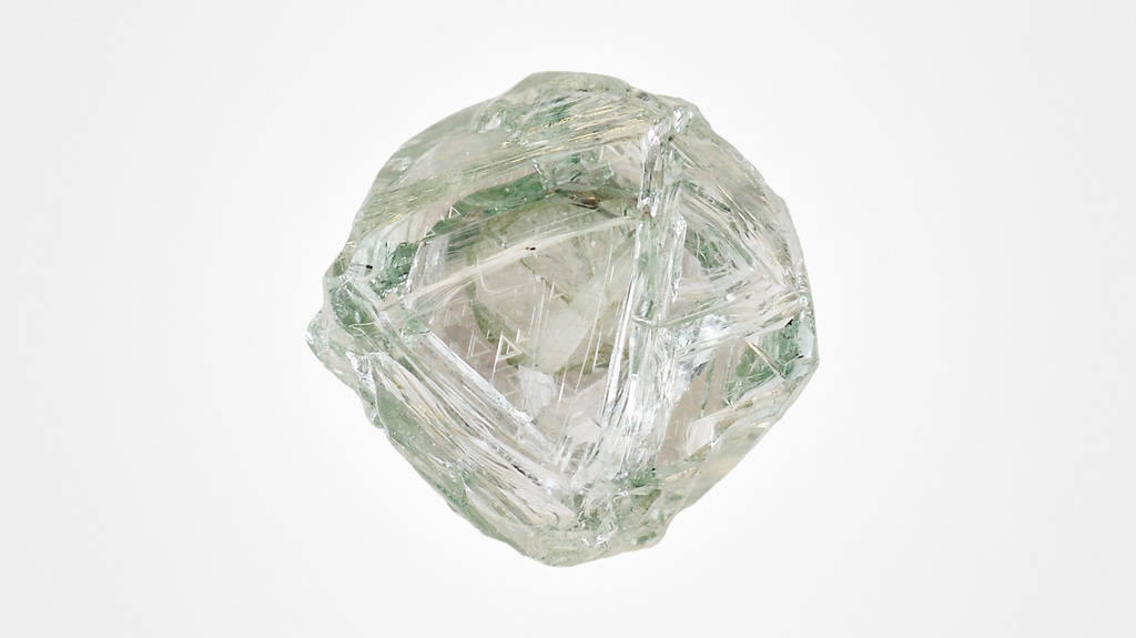 Natural diamond octahedra that have been partially resorbed by kimberlitic magma can have varied shapes and textures, as seen on this natural green diamond, known as the “Matryoshka,” with resorbed points and edges, and trigonal etching on its faces. Photo credit: Jian Xin (Jae) Liao Natural diamond octahedra that have been partially resorbed by kimberlitic magma can have varied shapes and textures, as seen on this natural green diamond, known as the “Matryoshka,” with resorbed points and edges, and trigonal etching on its faces. Photo credit: Jian Xin (Jae) Liao