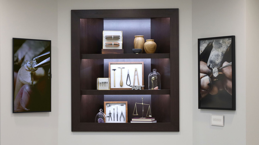 The interior of the store displays vintage jewelry-making tools and provides a viewing area to watch the store’s jewelers as they work. The interior of the store displays vintage jewelry-making tools and provides a viewing area to watch the store’s jewelers as they work.