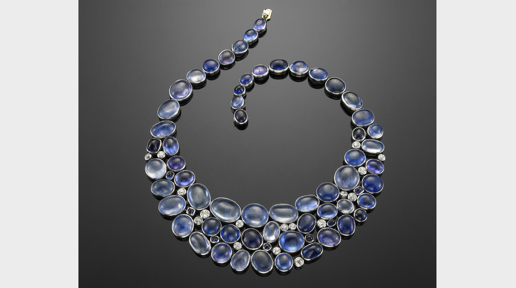 A “bib” necklace, 1940s, of cabochon sapphires interspersed with brilliant-cut diamonds by Suzanne Belperron, made by Groëné et Darde for Herz-Belperron. To achieve the effortless appearance of the color blends, Belperron is rumored to have tipped the sapphires onto a table and then carefully plotted them on the design. Courtesy of Belperron, LLC / Private collection (photo by David Behl) A “bib” necklace, 1940s, of cabochon sapphires interspersed with brilliant-cut diamonds by Suzanne Belperron, made by Groëné et Darde for Herz-Belperron. To achieve the effortless appearance of the color blends, Belperron is rumored to have tipped the sapphires onto a table and then carefully plotted them on the design. Courtesy of Belperron, LLC / Private collection (photo by David Behl)