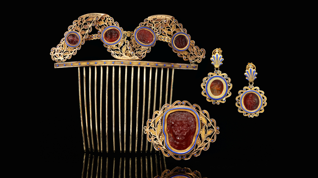 A hair comb, pendant earrings, and belt ornament accompany the matching gold, enamel and carnelian tiara pictured at top of article in the Sotheby’s London sale. A hair comb, pendant earrings, and belt ornament accompany the matching gold, enamel and carnelian tiara pictured at top of article in the Sotheby’s London sale.