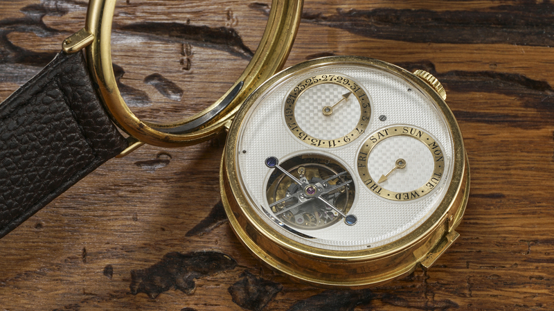 Released by a pusher, the case can be popped open to reveal the back dial.
