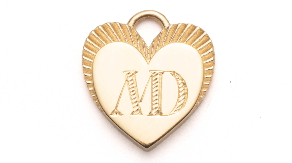 This “Textured Cypher” lettering is the same used in the last two letters of “Foundrae” in the company’s branding, combining letters into a single, connected glyph. It’s pictured here on the 12-millimeter miniature heart with guilloche border detailing ($995). This “Textured Cypher” lettering is the same used in the last two letters of “Foundrae” in the company’s branding, combining letters into a single, connected glyph. It’s pictured here on the 12-millimeter miniature heart with guilloche border detailing ($995).