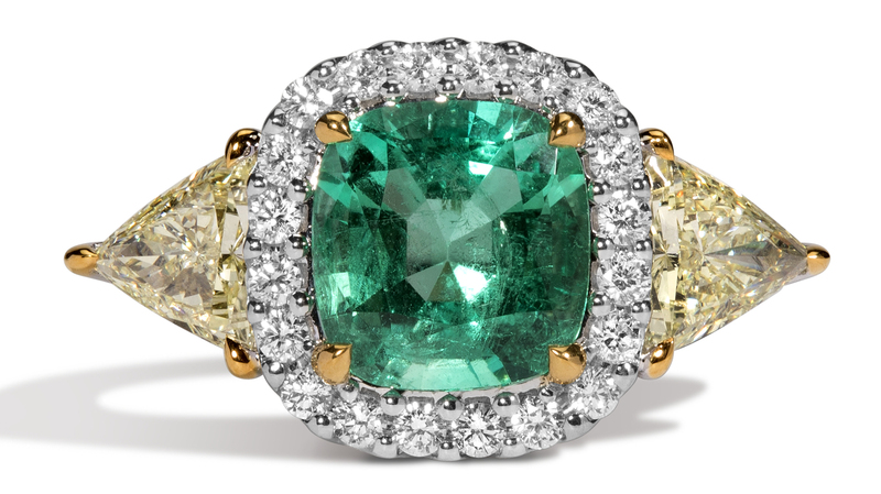 Nova l'Œil Jaune Ring in 18-karat white gold with Muzo cushion-cut 2.37-carat emerald, 1.20 carats of yellow diamond trillion side stones, and 0.37 carats of white diamonds ($16,625)