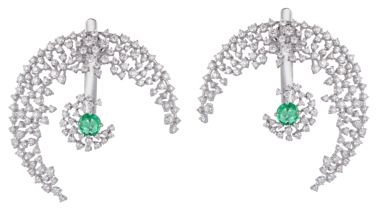 Scatter Moon earrings in 18-karat white gold with 3.7 carats of diamonds and 1.21 carats of emeralds ($5,810). The “crescent moon” component can be worn on its own, without the emerald jacket.