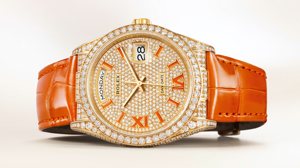 The diamond-set 18-karat yellow gold Day-Date 36 with the coral-colored alligator strap and markers retails for $82,500. The Everose with burgundy and the white gold version with turquoise are both $85,000.