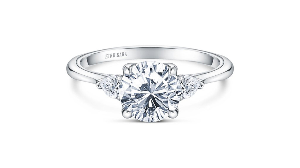 The classic three-stone ring gets an update with fancy-shape side stones. This ring from the “Stella” collection is a new style from Kirk Kara, featuring 0.2 carats of diamonds and milgrain and filigree details ($2,520 without center stone).