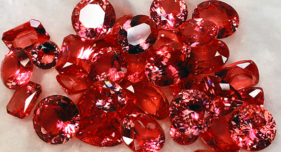 A selection of faceted rhodochrosite gemstones from the Detroit City Portal in Colorado (Photo courtesy of Iteco Inc.)