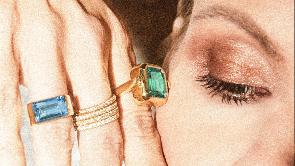 At right is the collection’s swivel ring, which features a different colored gemstone on each side. At right is the collection’s swivel ring, which features a different colored gemstone on each side.