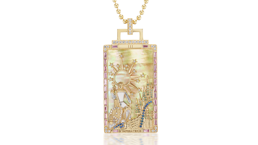“L’Imperatrice” or “The Empress” tarot card pendant in 18-karat yellow gold with 15.10 carats of yellow mother-of-pearl, 1.65 total carats of color-change garnet, green sapphire, blue sapphire, and diamond ($19,500). Sorellina engraves the name of each tarot card pendant in Italian, a nod to the sisters’ heritage. “L’Imperatrice” or “The Empress” tarot card pendant in 18-karat yellow gold with 15.10 carats of yellow mother-of-pearl, 1.65 total carats of color-change garnet, green sapphire, blue sapphire, and diamond ($19,500). Sorellina engraves the name of each tarot card pendant in Italian, a nod to the sisters’ heritage.